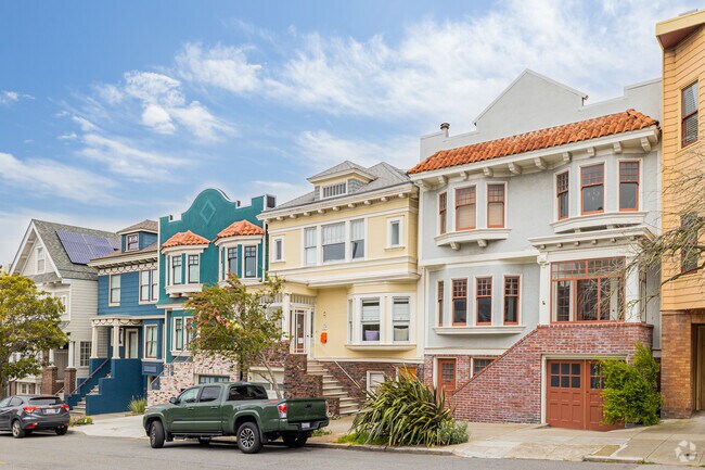 Two art-deco-style and two craftsman-style homes alternate on an Inner Sunset street.
