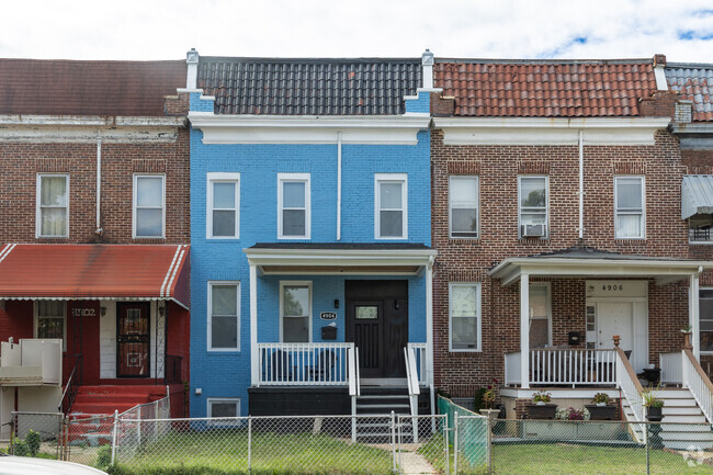 A newly renovated row home is painted blue in Langston Hughes.