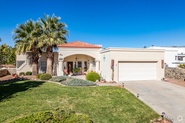 This ranch-style Mediterranean home has a lawn and tile roof in High Range.