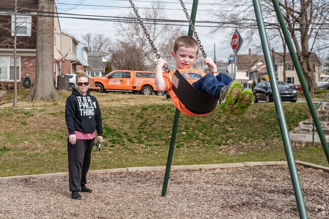A young boy at Glenolden Park enjoys the warm weather on the swings.