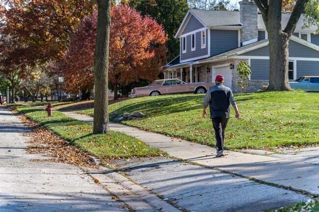 Tree-lined streets in Pewaukee Village offer a peaceful setting for an afternoon walk.