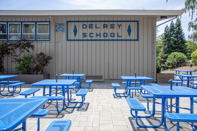 Lunch is outside at Del Rey School with colorful tables.
