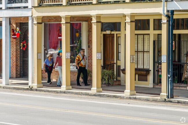 Residents of St Martinville take a stroll along the main street shopping area.