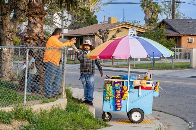 A street vendor sells his treats to an Oakridge couple.
