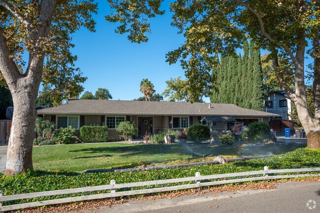 Nestled in nature's embrace, this ranch house beckons you to explore its timeless charm.