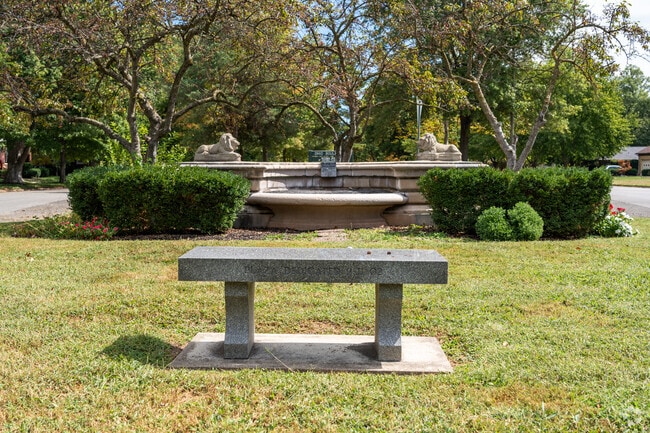 Ohio Boulevard Park is a small green-Ohio Boulevard Park features landscaping and stone artwork near historic homes.