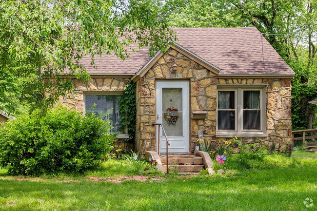 A cape cod style bungalow is finished with local field stone in Tom Watkins.