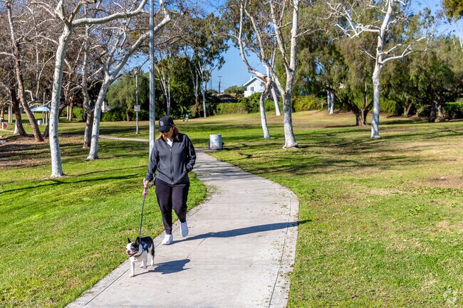 Hilltop Park Pathway with someone walking their dog in Hilltop, Chula Vista, California.