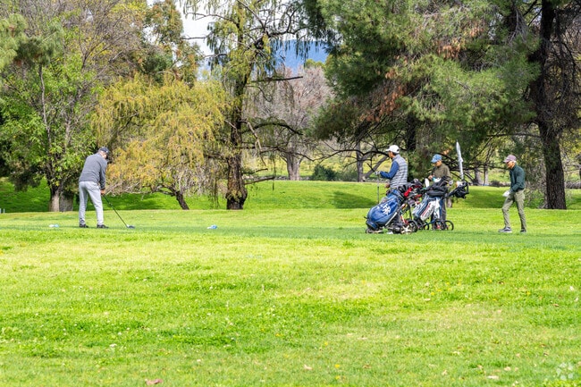 Golfers make their way through the course at the Hansen Dam Golf Course.