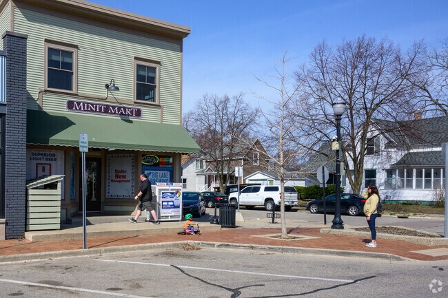 A mother and child hangout near the Mini Mart, which offers groceries and other items in Washington Square.