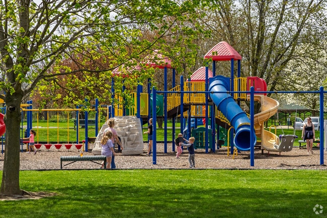A colorful central play structure is ringed with swings for kids of all ages at Tate Park.
