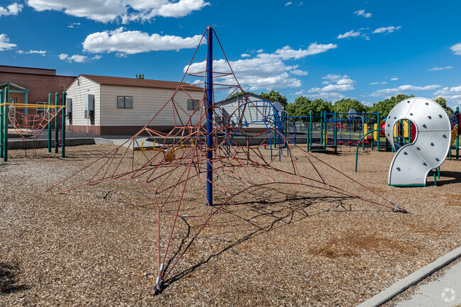 A cement border contains Hayden Peak Elementary School’s playground.