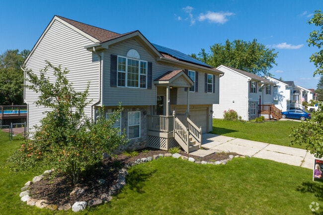A row of split-level homes lines a newer residential subdivision in Fenton Township.