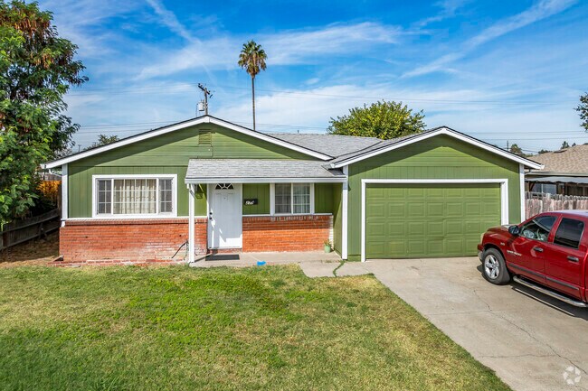 This ranch-style home is smaller with a 2-car garage and brick accents in Strawberry Manor.