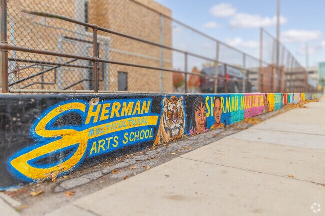 This short wall mural shows the art of Sherman Multi-Cultural Arts School in St Joseph's.
