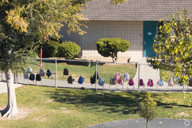 Backpacks hanging on the fence at William E. Fanning Elementary of Brea.