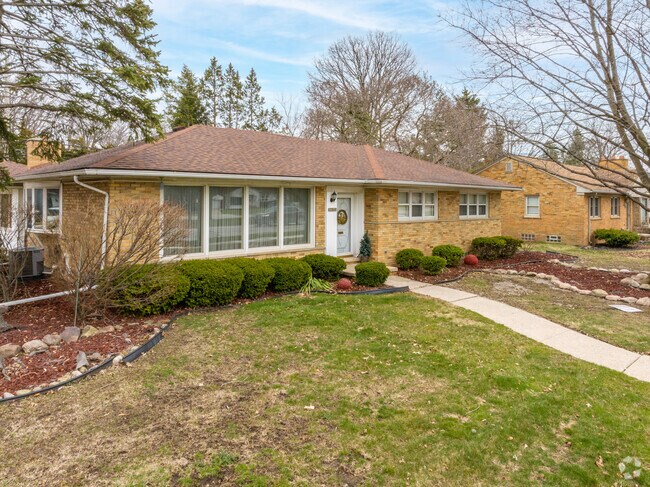 The brick ranch home showcases a perfect blend of classic style and modern comfort.