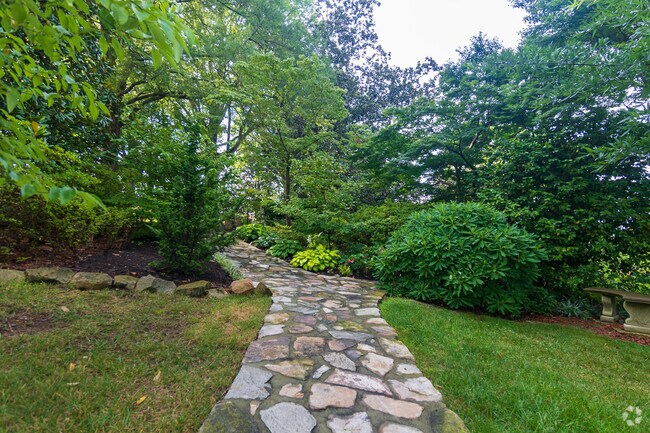 A stone walkway leads to a meditation area in Memorial Garden in Downtown Concord