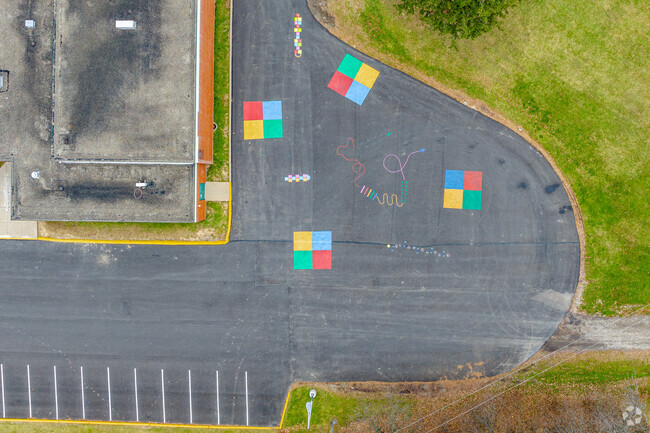 Students leave behind murals on the pavement at Greenock Elementary School.