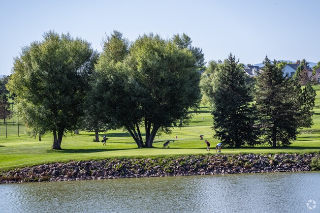 Golfers putt near the lake at Indian Tree Golf Club near Parkway Estates, Arvada, Colorado.