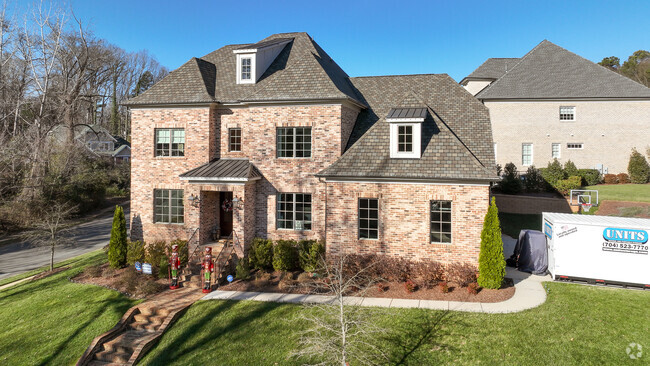 Brick, two-story manors are a common home style within the Beverly Woods neighborhood.