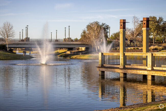 The new subdivisions of Iowa Colony have amenities like stocked fishing ponds with docks.