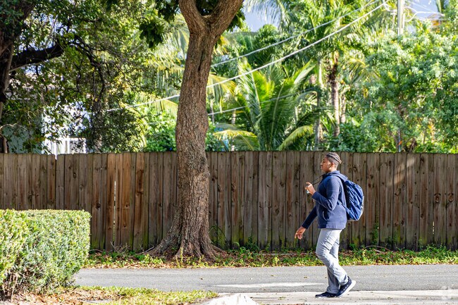 A kid is walking home from school in Northshore.