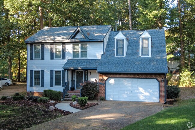 Colonial home surrounded by trees in the Kiln Creek neighborhood.