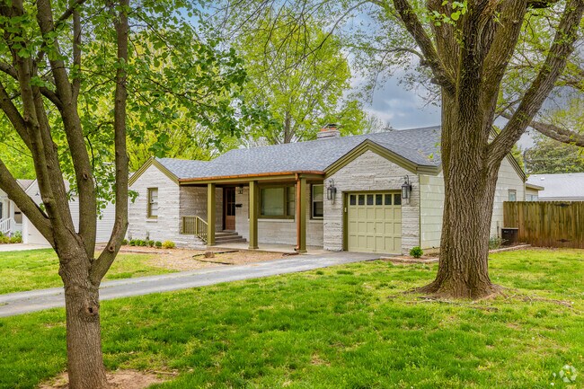 An updated ranch home sits beneath 2 large shade trees in the University Heights neighborhood.