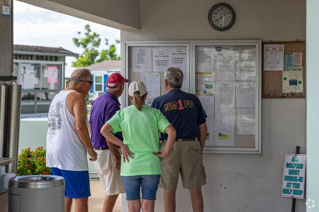 A community board at Del Tura Golf & Country Club lists activities and clubs for Jacaranda residents.