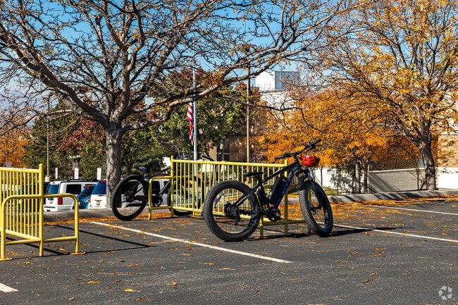 Bikes parked under fall trees in White City Township.