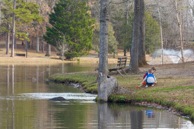 Children playing near the water of Park Road Park.