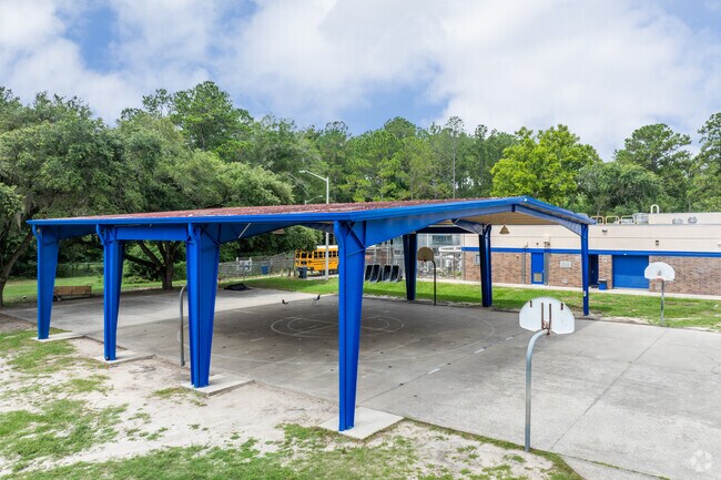 Students play basketball in the shade at Kimball Wiles Elementary School.