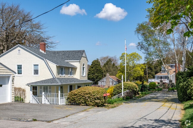 Wooded lot surrounds this classic two-story residence in Touisset Highlands.