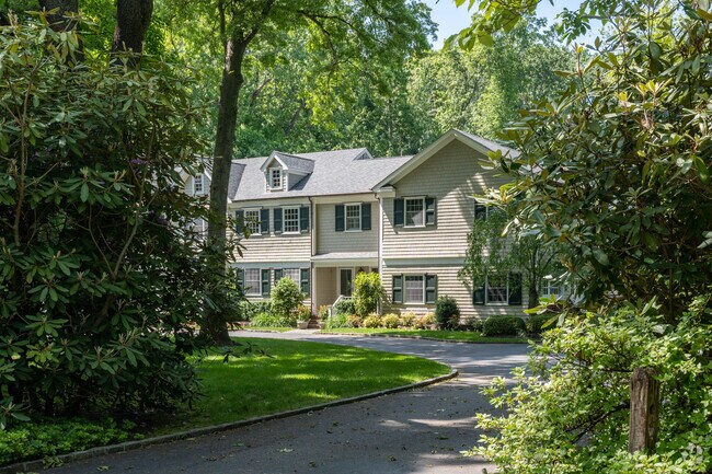 A stately colonial home sits on a spacious lot in Old Brookville, New York.