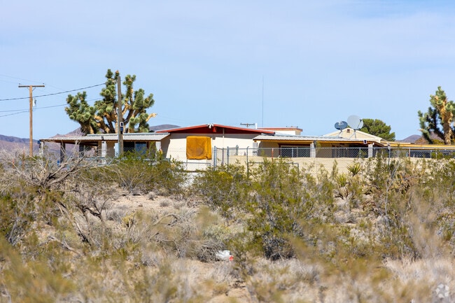 A quiet property with a covered porch offers a retreat in the Mojave Desert.