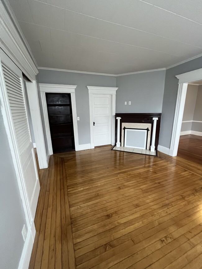 Living room with built in bookcase and fireplace (non-active).