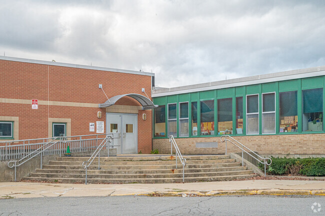 The red brick and teal accents help to identify Naquag Elementary School.