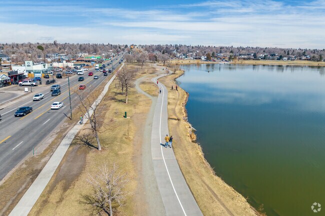 Walkers, bikers, and rollerbladers loop the pedestrian path at Sloan Lake in Edgewater.