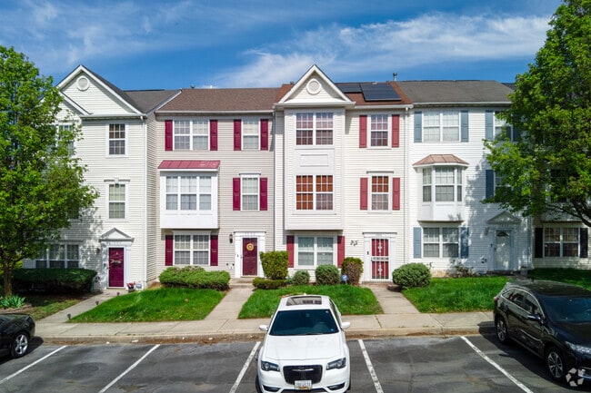 Townhomes with red accents line Drylog St in Peppermill Village.