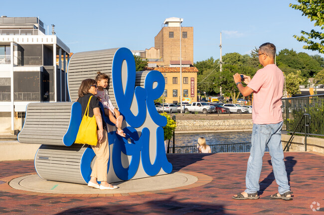 This family captures a meaningful moment next to the 'Be You' sculpture at First Street plaza.