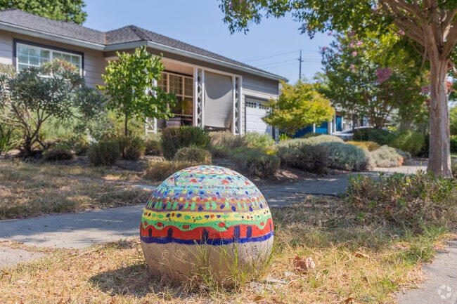 A beautifully painted stone sits along the sidewalk in the Terrace neighborhood.