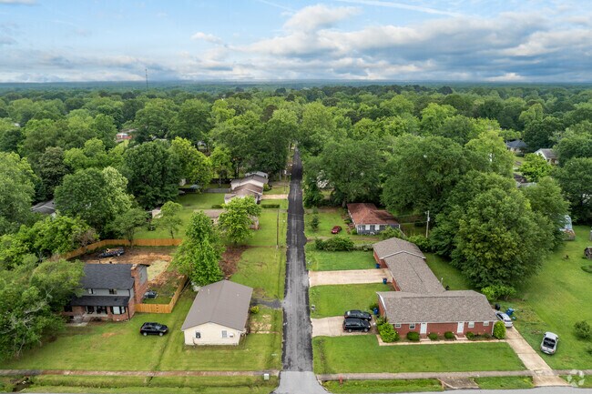 Homes in Beebe are surrounded by tall trees.