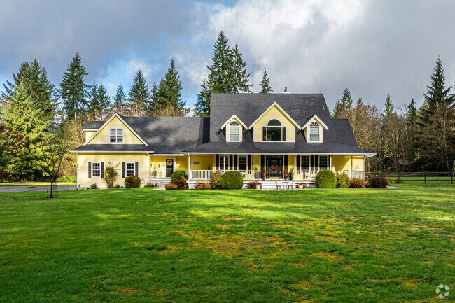 A stunning yellow farmhouse on a large lot in the Cherry Gardens neighborhood.