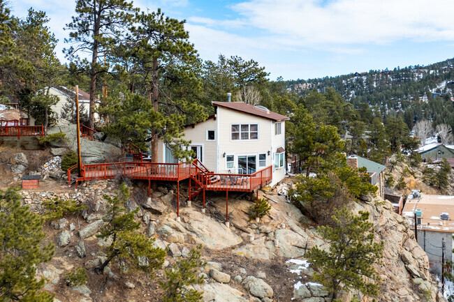 Trees surround homes in Evergreen, & A-frame cabins & chalet-style homes are most common.