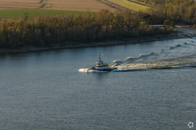 A tugboat steams by Darrow on the Mississippi River.