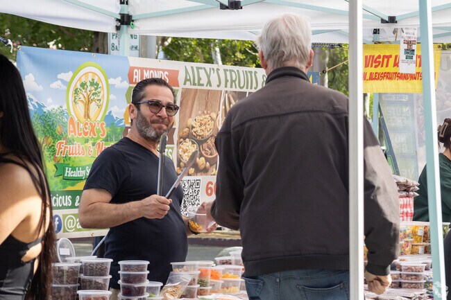 Alex the happy fruit and nut vendor shares his products at the Redlands Farmers' Market.