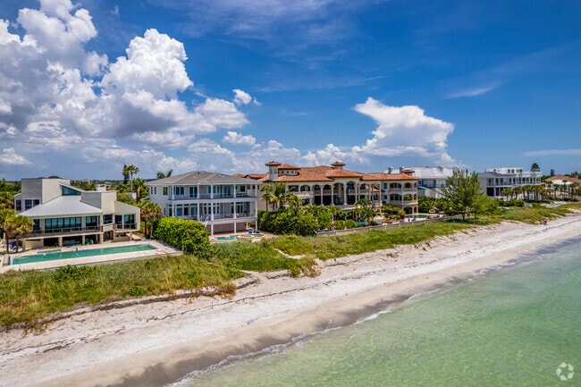 Belleair Beach’s beachfront is framed by high-end homes and tropical landscaping.