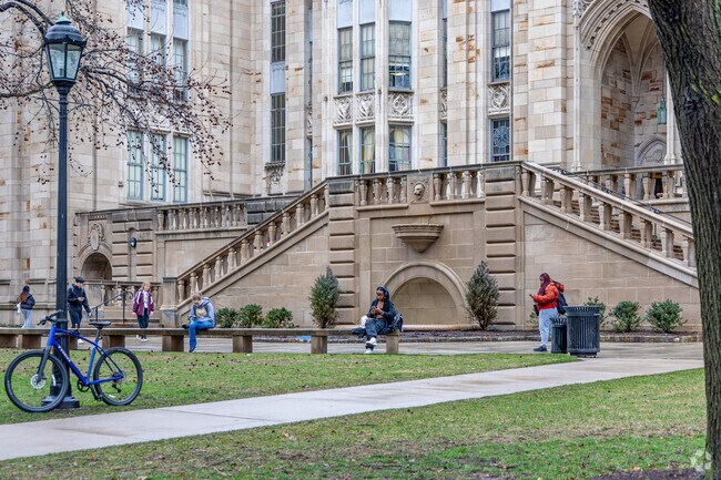 A student near West Oakland reads a book outside of the Cathedral of Learning.