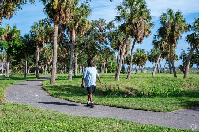 Residents of Highland Oaks unwind along the paths at Dell Holmes Park.